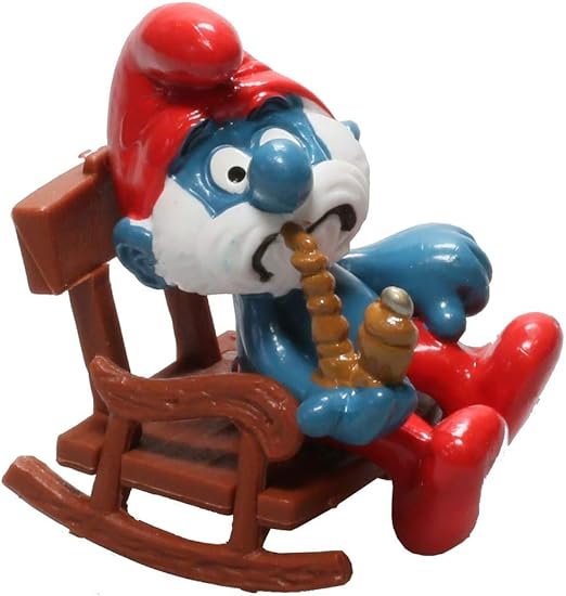 Schleich Gammelsmurfen sittande i gungstol, samlarfigur från 1994 i originalförpackning, ca 5,5 cm hög, nostalgisk Smurf-modell.
